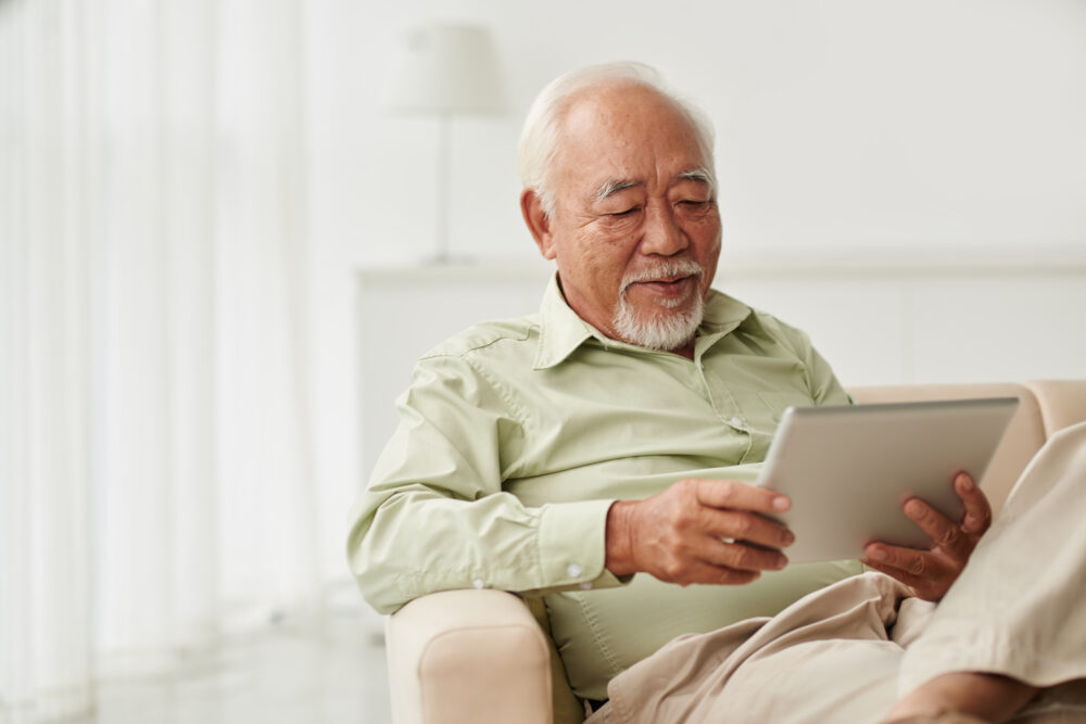 Elderly man on tablet